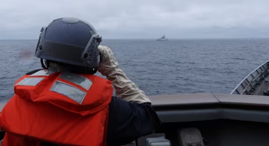 Taiwanese sailor watching a Chinese warship