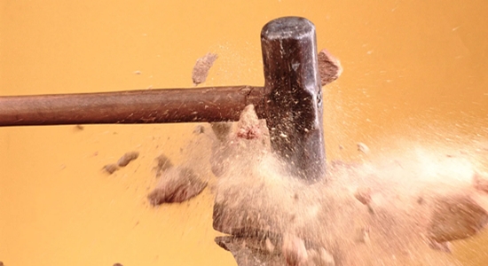 A mallet smashing and pulverizing