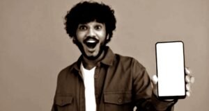 An Indian man holding an iPhone