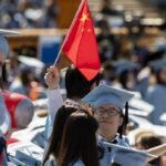A graduate with a flag of the People's Republic of China