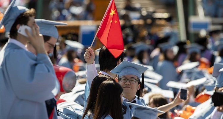 A graduate with a flag of the People's Republic of China