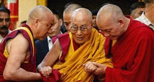 Monks assist a frail Dalai Lama
